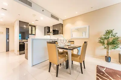 a kitchen and dining room with a table and chairs at Prime Waterfront Living, Just Moments from Marine Transport, Bus Stops, and Dubai Water Canal, Waters Edge, Business Bay by Deluxe Holiday Homes in Dubai