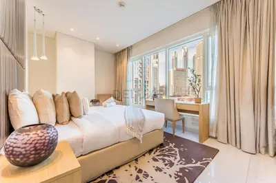 a bedroom with a large bed with a large window at Prime Waterfront Living, Just Moments from Marine Transport, Bus Stops, and Dubai Water Canal, Waters Edge, Business Bay by Deluxe Holiday Homes in Dubai