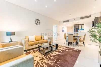 a living room with a couch and a table at Prime Waterfront Living, Just Moments from Marine Transport, Bus Stops, and Dubai Water Canal, Waters Edge, Business Bay by Deluxe Holiday Homes in Dubai