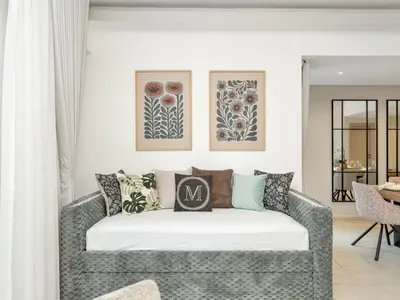 a living room with a couch with pillows on it at Kensington-2BR Huge & Central at Executive Tower in Dubai