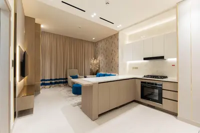 a kitchen with a sink and a stove top oven at The Royale Blue Luxury Suite 325 Private Plunge Pool in Dubai