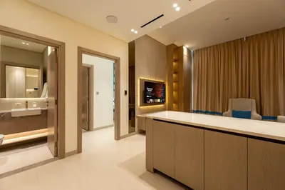 a bathroom with a sink and a counter with chairs at The Royale Blue Luxury Suite 325 Private Plunge Pool in Dubai