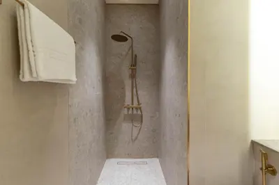 a shower with a shower head in a bathroom at The Royale Blue Luxury Suite 325 Private Plunge Pool in Dubai