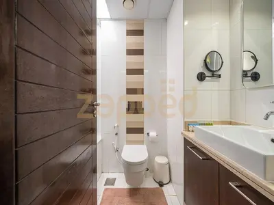 a bathroom with a white toilet and a sink at Zapbed Stylish Studio Boulevard Central 2 Down Town Dubai in Dubai