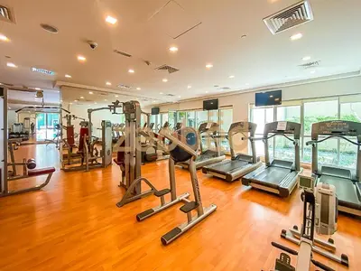 a gym with several tread machines in a room at Zapbed Stylish Studio Boulevard Central 2 Down Town Dubai in Dubai