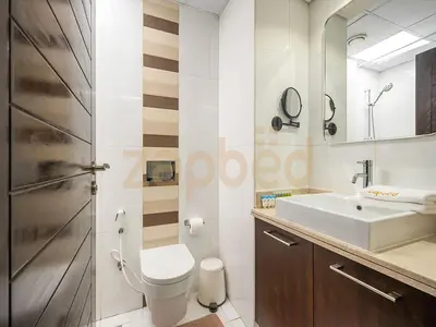 a bathroom with a toilet and a sink at Zapbed Stylish Studio Boulevard Central 2 Down Town Dubai in Dubai