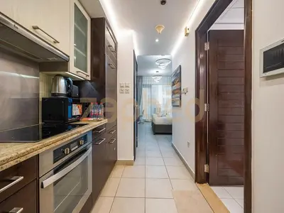a kitchen with a sink and a stove top oven at Zapbed Stylish Studio Boulevard Central 2 Down Town Dubai in Dubai