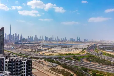 an aerial view of a city with buildings and highways at Bright 1BR in Sobha Crest B Stunning Views & Pool in Dubai