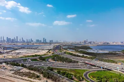 an aerial view of a highway with a city in the background at Bright 1BR in Sobha Crest B Stunning Views & Pool in Dubai
