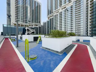 a playground in a city with tall buildings at Bright 1BR in Sobha Crest B Stunning Views & Pool in Dubai