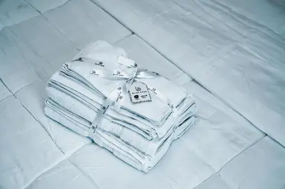 a pile of towels sitting on a bed at Luxury 1BR Apartment near Burj Khalifa & Dubai Mall in Dubai