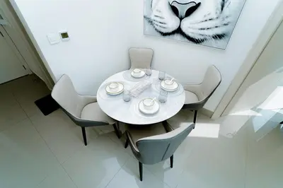 a dining room with a white table and chairs at Luxury 1BR Apartment near Burj Khalifa & Dubai Mall in Dubai