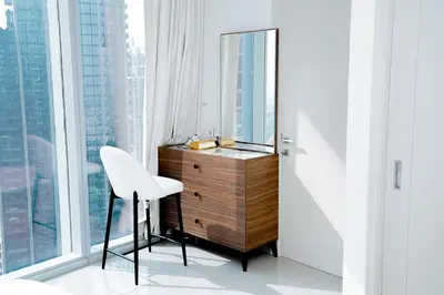 a dressing room with a mirror and a dresser and a chair at Luxury 1BR Apartment near Burj Khalifa & Dubai Mall in Dubai