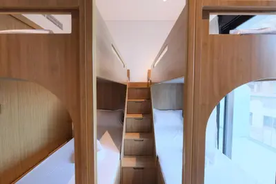 a room with two bunk beds and a window at Modern 2BR Retreat Azizi Riviera 61 Square in Dubai