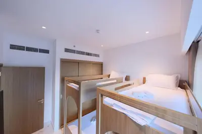 a small room with two bunk beds in it at Modern 2BR Retreat Azizi Riviera 61 Square in Dubai