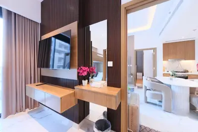 a living room with a table and a dining room at Modern 2BR Retreat Azizi Riviera 61 Square in Dubai