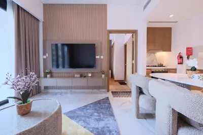 a living room with a flat screen tv on a wall at Modern 2BR Retreat Azizi Riviera 61 Square in Dubai