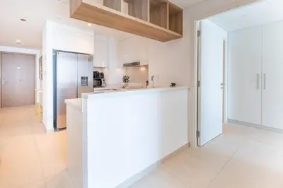 a kitchen with white cabinets and a counter top at Stylish 2BHK with Burj Khalifa Views in Downtown in Dubai