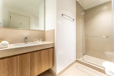 a bathroom with a sink and a shower at Stylish 2BHK with Burj Khalifa Views in Downtown in Dubai