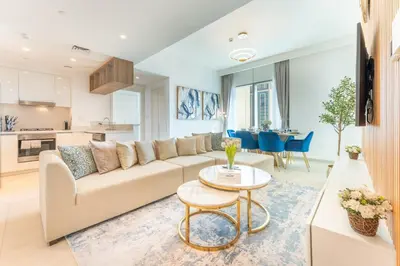 a living room with a couch and a table at Stylish 2BHK with Burj Khalifa Views in Downtown in Dubai