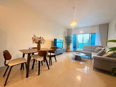 a living room with a table and a couch at Panoramic Luxury 1BR at Park Towers, DIFC, Dubai, Stunning City View in Dubai