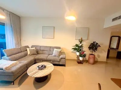 a living room with a couch and a table at Panoramic Luxury 1BR at Park Towers, DIFC, Dubai, Stunning City View in Dubai