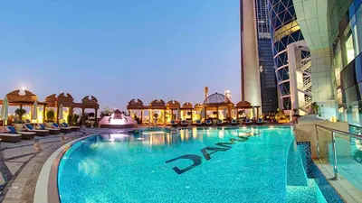 a large swimming pool in a building with a hotel at Panoramic Luxury 1BR at Park Towers, DIFC, Dubai, Stunning City View in Dubai