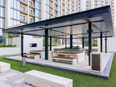 a pavilion with benches and tables in a city at Elegant 1BR Sobha Crest City Views in Dubai