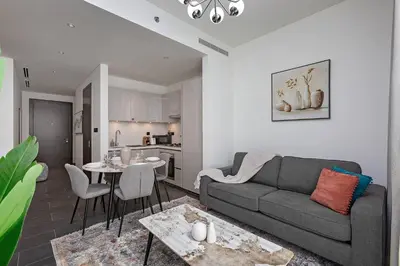 a living room with a couch and a table at Chic 1BR Retreat Sobha Crest with Pool & Gym in Dubai