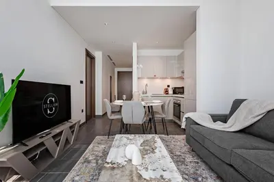 a living room with a couch and a table at Chic 1BR Retreat Sobha Crest with Pool & Gym in Dubai