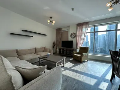 a living room with a couch and a tv at sanibel tower in Dubai