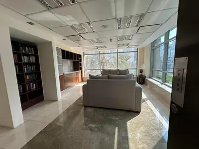a living room with a couch and a large window at sanibel tower in Dubai