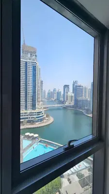 a window with a view of a body of water at Bay Central 1BR with Full Marina View in Dubai