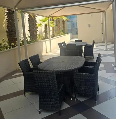 a patio with tables and chairs under a tent at Bay Central 1BR with Full Marina View in Dubai