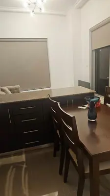 a room with a table and chairs and a large screen at Bay Central 1BR with Full Marina View in Dubai