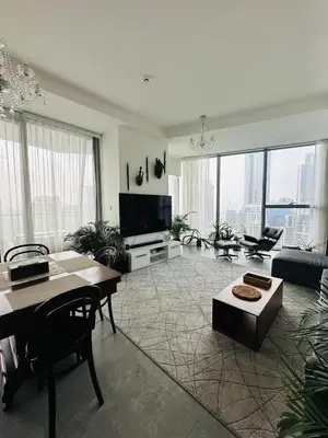 a living room with a television and a table and chairs at Amazing apartment on Stella Maris 2BR in Dubai