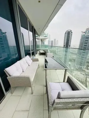 a balcony with couches and a table on a building at Amazing apartment on Stella Maris 2BR in Dubai