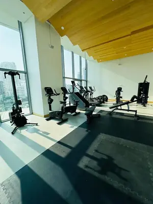 a gym with several tread machines in a room with windows at Amazing apartment on Stella Maris 2BR in Dubai