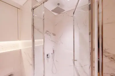 a shower with a glass door in a bathroom at Modern Studio Azizi Riviera 59 Al Merkadh Community in Dubai