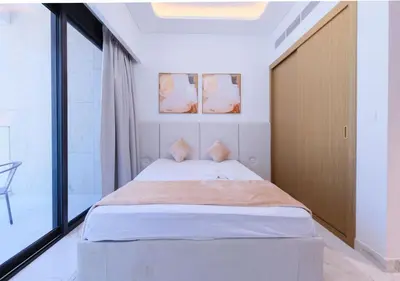 a bedroom with a bed and a large window at Modern Studio Azizi Riviera 59 Al Merkadh Community in Dubai