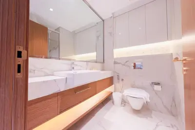 a bathroom with a sink and a toilet and a mirror at Modern Studio Azizi Riviera 59 Al Merkadh Community in Dubai