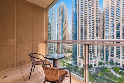 a balcony with a table and chairs and a view of a city at Downtown View 2BHK in Dubai
