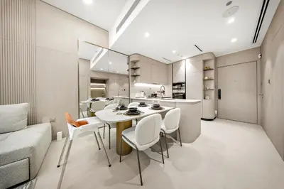 a kitchen and dining room with a table and chairs at Spacious 1BR in JVC with Lounge Access in Dubai