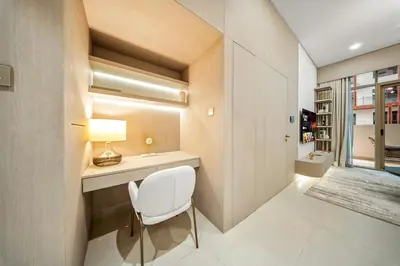 a small room with a white chair and a desk at Spacious 1BR in JVC with Pool and Gym Access in Dubai