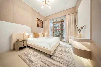 a bedroom with a white bed and a window at Spacious 1BR in JVC with Pool and Gym Access in Dubai