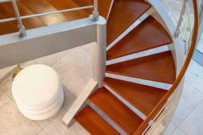 a spiral staircase in a building at Daniels 2BR Duplex at Central Park Tower, DIFC in Dubai