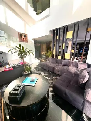 a living room with a couch and a coffee table at Iconic Triplex Penthouse in Marina in Dubai