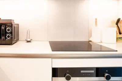 a kitchen with a toaster oven and a microwave at The Address JBR, Address Beach Resort, Marina View - Onelink in Dubai