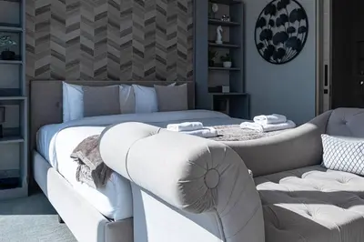 a bedroom with a bed and a couch at The Address JBR, Address Beach Resort, Marina View - Onelink in Dubai