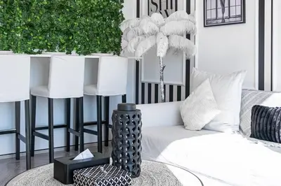 a living room with a couch and a vase on a table at The Address JBR, Address Beach Resort, Marina View - Onelink in Dubai
